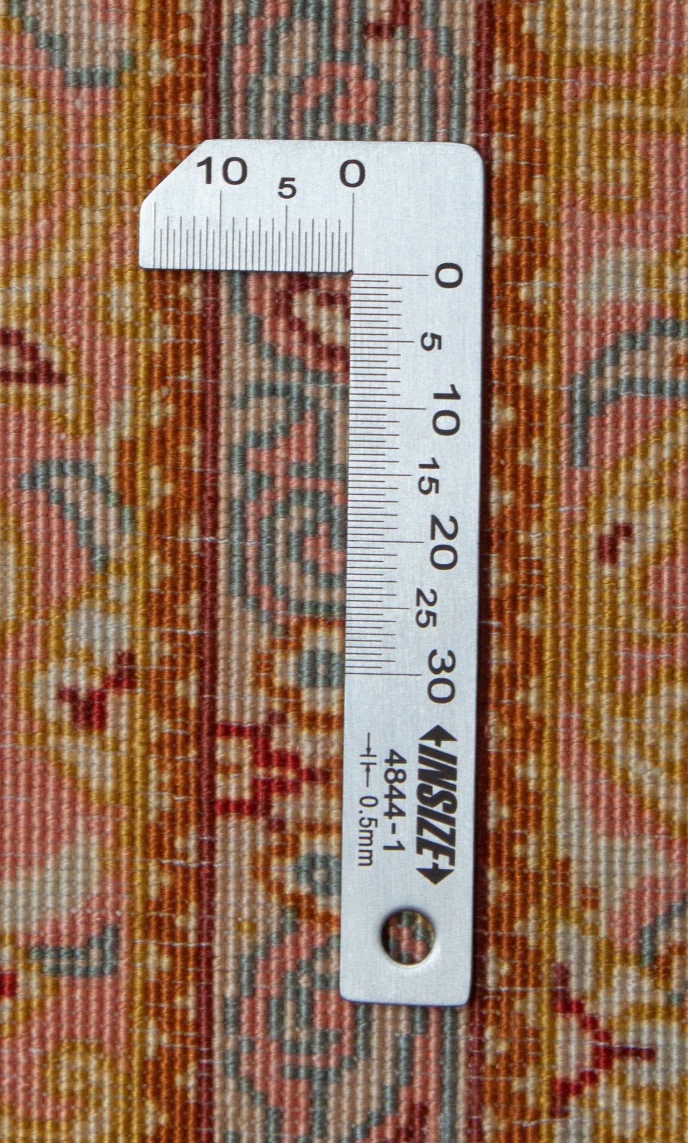 Eine Fotoaufnahme eines Ghom Teppichs.