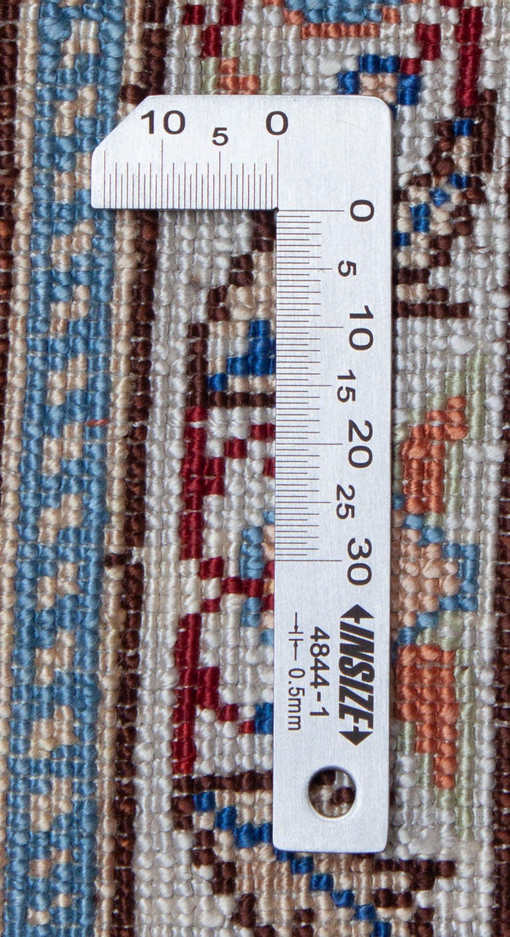 Eine Fotoaufnahme eines Hereke Teppichs.